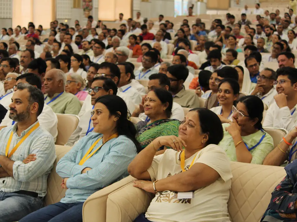 A large audience seated in the hall during the reception
