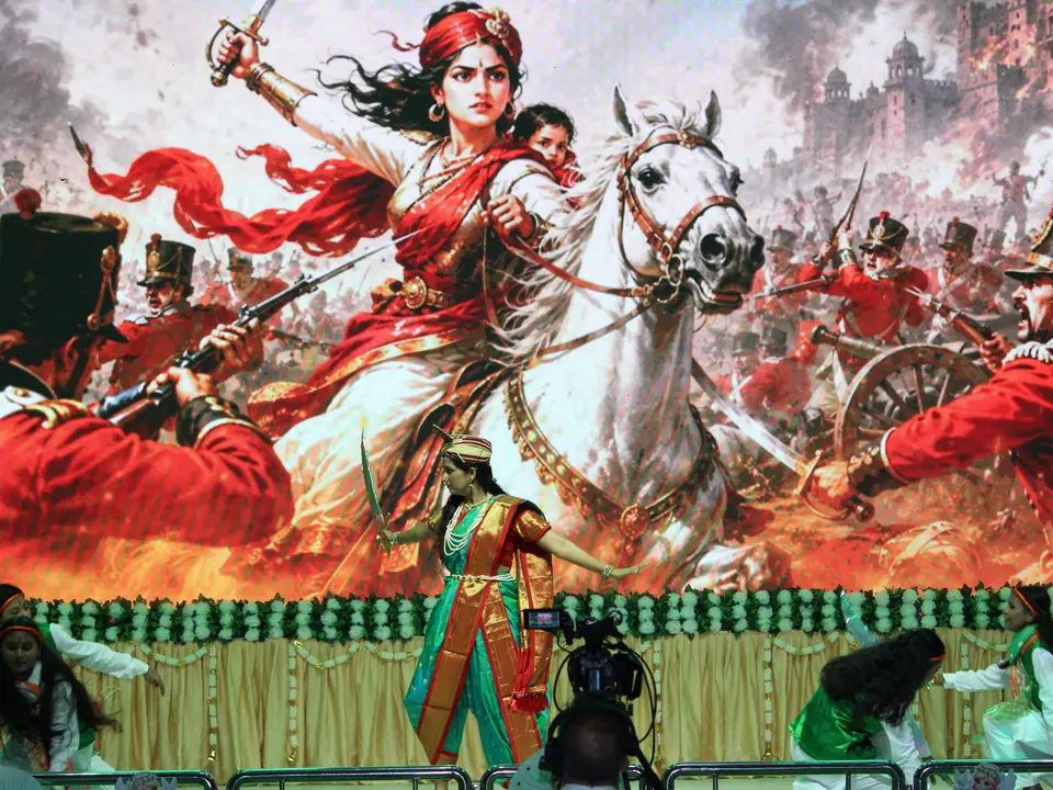 A performance backdrop showing Rani Lakshmibai on horseback