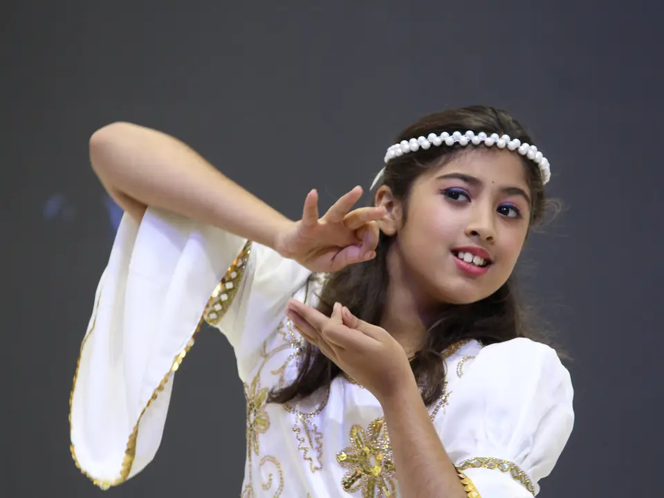 A child performing a dance during the valedictory session