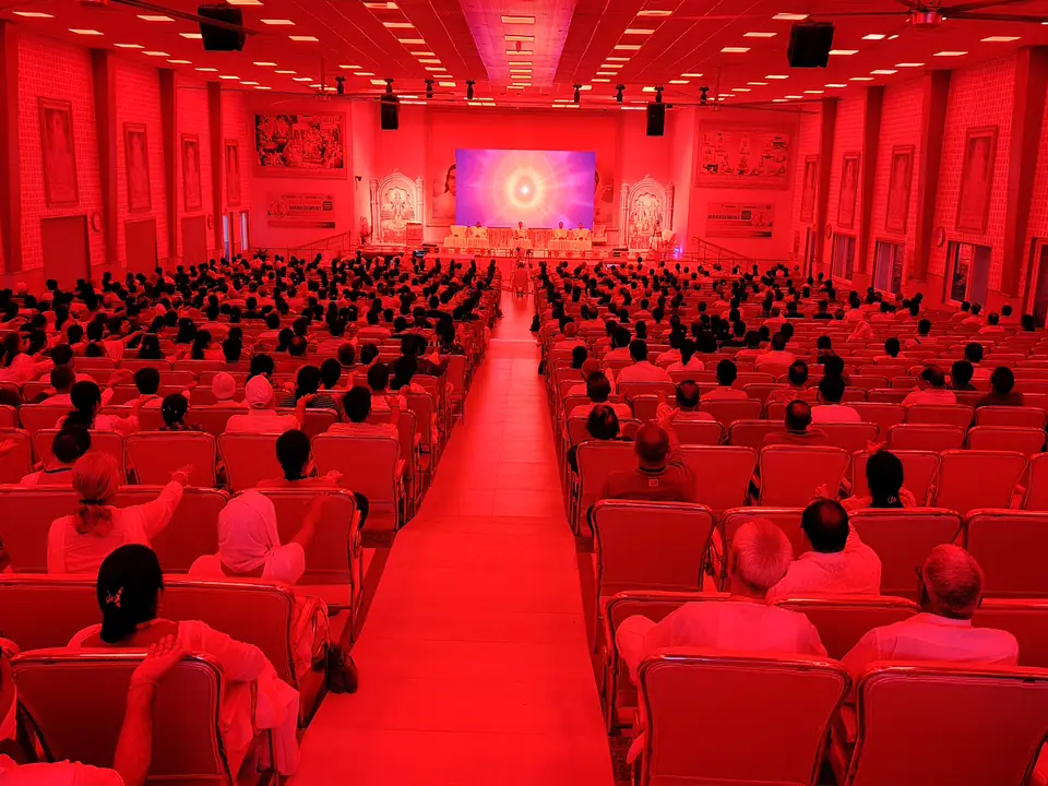 The conference hall lit in red before dawn meditation